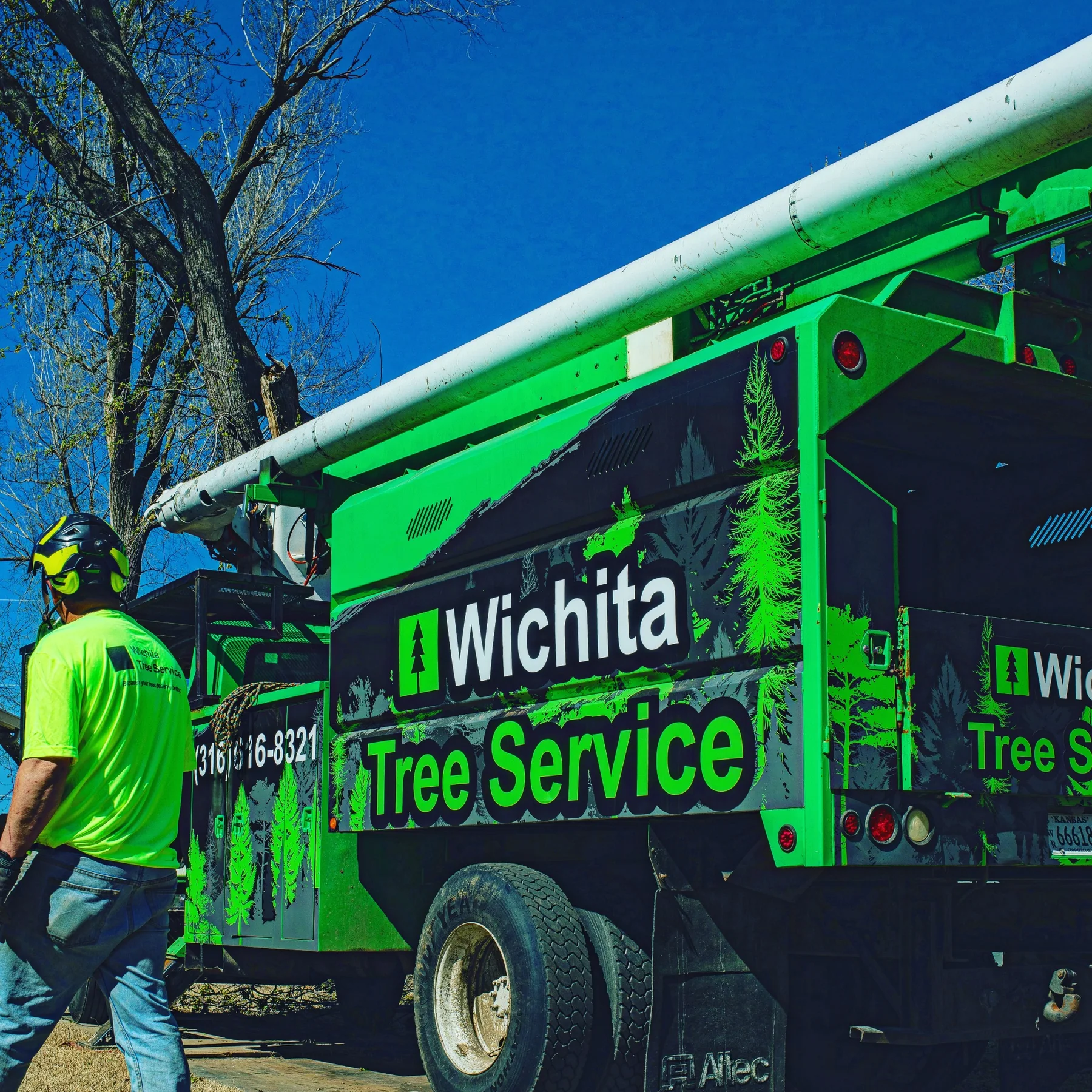 Wichita Tree Service bucket truck and crew on a tree job